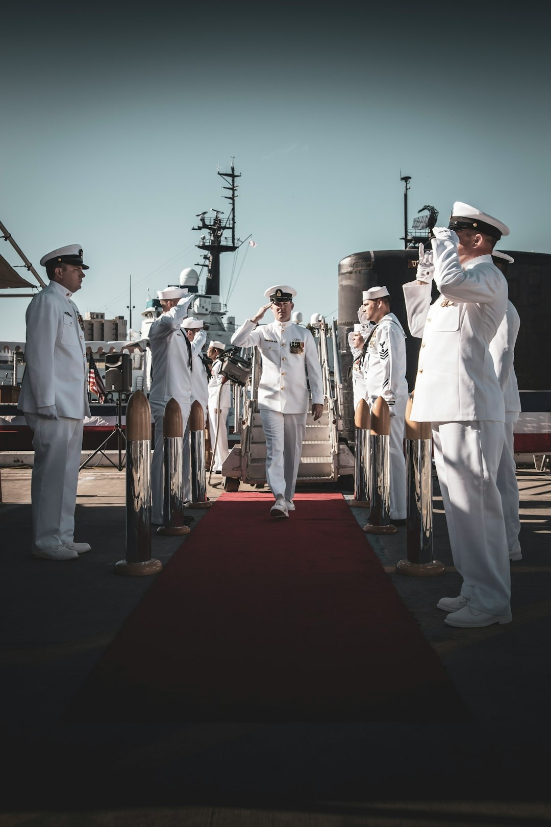 Navy sailors in dress whites aboard ship